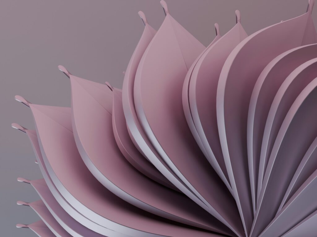 A close up of a pink flower on a gray background